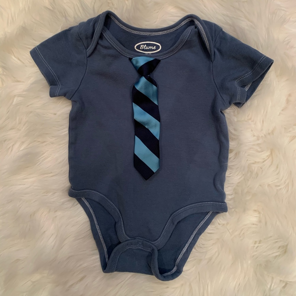 Blue onesie with attached tie.
